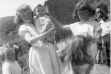683: l-r Rosemary Norman, Geraldine Norman holding baby Calvin Kerrivan, Hilda Norman and William  Norman, with Elizabeth Lambe in front (back to camera). At Margarees Cove, Red Island. (circa 1956) [courtesy of Jenny (Kerrivan) Harvie]  - Rosemary, Geraldine, Hilda and William children of Michael Norman &amp;amp; Elizabeth Counsel; Calvin  son of Leo Kerrivan &amp;amp; Sarah Norman; Elizabeth daughter of Patrick Lambe &amp;amp; Mary Kerrivan